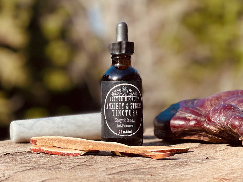Nicole's Apothecary Anxiety & Stress Tincture on stone with reishi mushroom, ashwaghanda, and a marble pestle